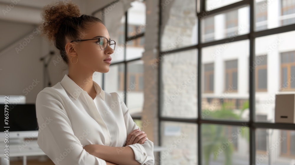 A confident young professional business woman working from a coworking space. Focused and thinking A confident young professional business woman working from a coworking space. Focused and thinking