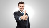 Businessman is doing thumps up sign over white background