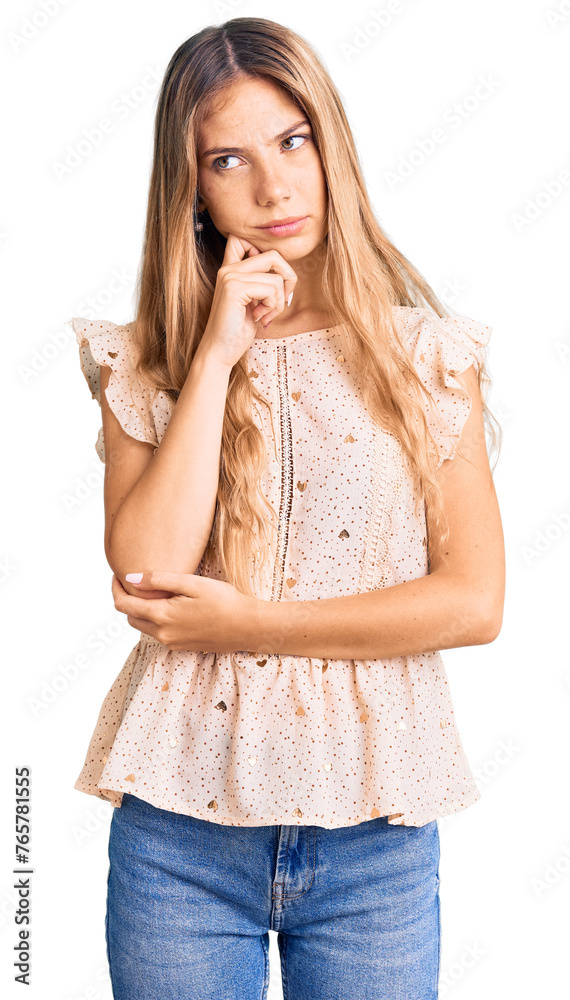 Beautiful caucasian woman with blonde hair wearing elegant summer clothes serious face thinking about question with hand on chin, thoughtful about confusing idea Beautiful caucasian woman with blonde hair wearing elegant summer clothes serious face thinking about question with hand on chin, thoughtful about confusing idea