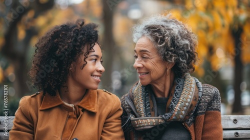 Grandmother with adult daughter having conversation on outdoor photo