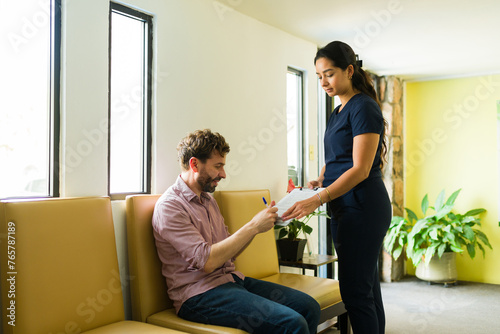 Patient and nurse in the waiting room signing papers before an alternative treatment