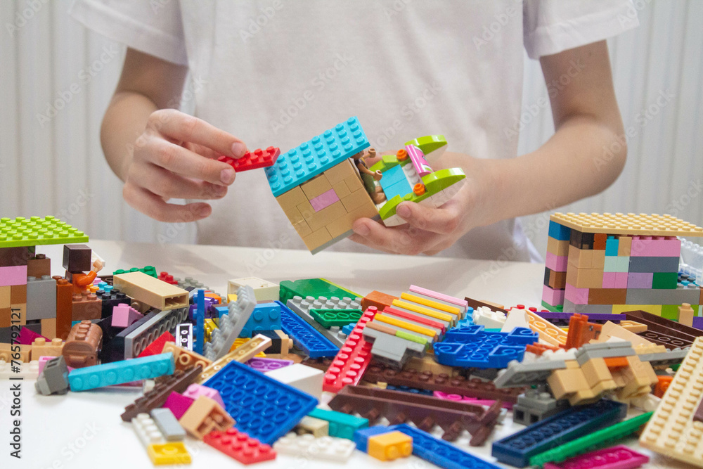 Fototapeta premium 8 year old child collects Lego
