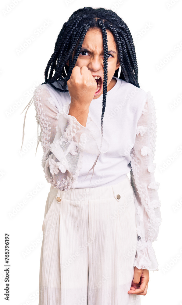 Cute african american girl wearing casual white tshirt angry and mad raising fist frustrated and furious while shouting with anger. rage and aggressive concept.