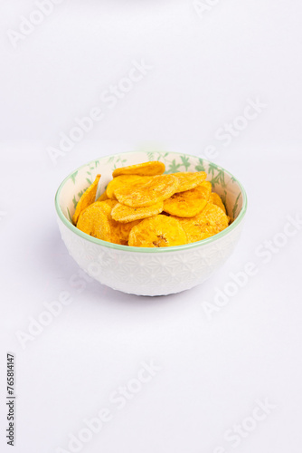 Green banana chips in a bold on white background vertical