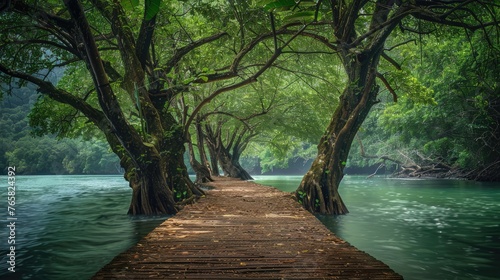 A tranquil wooden walkway along a misty river flanked by lush green trees.