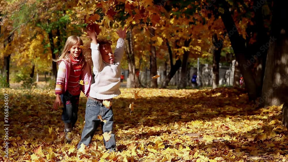 Yellow Game. Children playing with leaves in autumn park Yellow Game. Children playing with leaves in autumn park