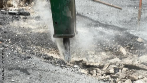 Dismantling of asphalt concrete pavement with pneumatic jackhammer during road works