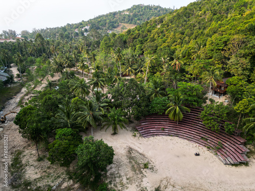 Aerial drone view small Koh Ma island, Ko Phangan Thailand. Exotic coast panoramic landscape, Mae Haad beach, summer day. Sandy path between corals. Vivid seascape, mountain coconut palms from above.