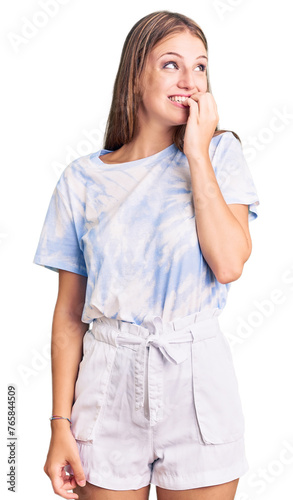 Photography Young beautiful blonde woman wearing tye die tshirt looking stressed and nervous with hands on mouth biting nails