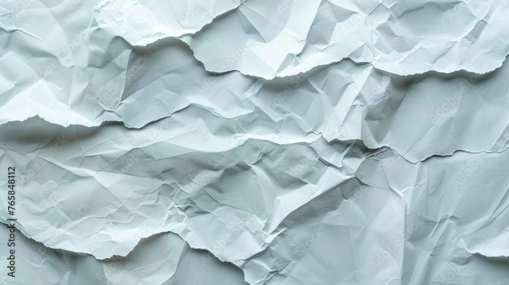 Crumpled blank white paper on textured background.