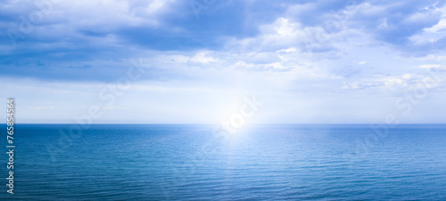 Calm windless ocean with the sun on the horizon. © Serghei V