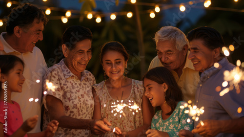 A family with sparklers are smiling and enjoying a festive evening outdoors.