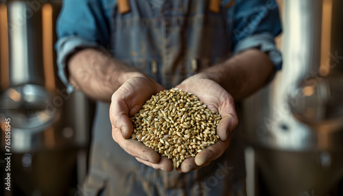 Close up of a brewer holding malt in his hands in a Brewery photo