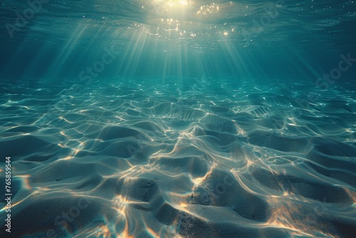 Underwater sand ripples bathed in sunlight, showcasing the tranquil beauty of the sea floor.