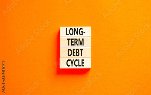 Long-term debt cycle symbol. Concept words Long-term debt cycle on beautiful wooden block. Beautiful orange table orange background. Business Long-term debt cycle concept. Copy space.