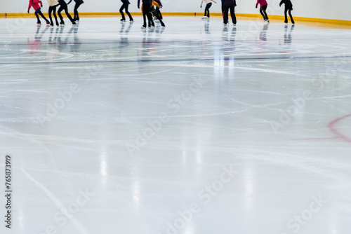 Indoor year-round ice rink. People skate on a skating rink on artificial ice. Skates ride on artificial ice