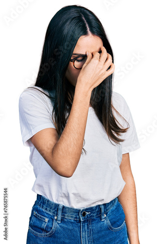 Young hispanic woman wearing casual clothes and glasses tired rubbing nose and eyes feeling fatigue and headache. stress and frustration concept.
