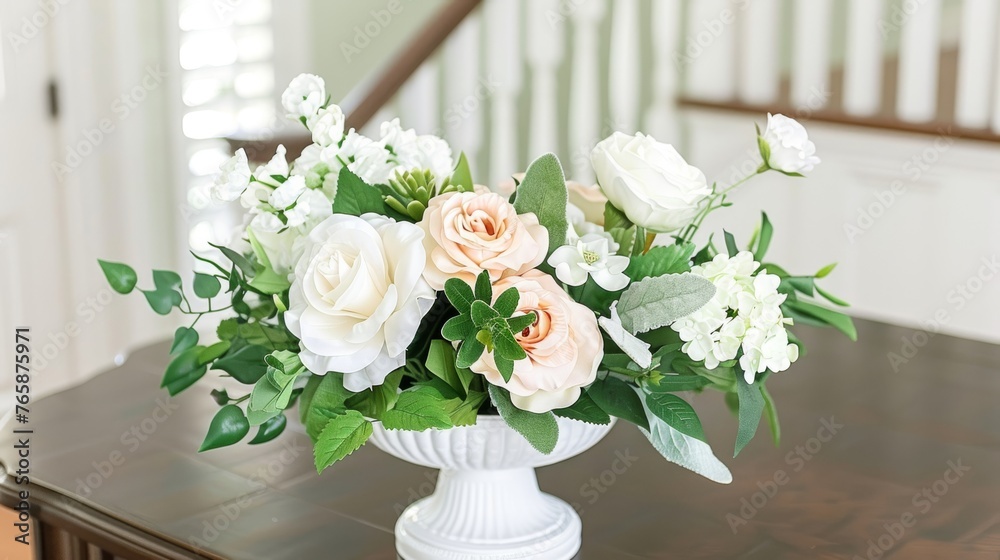 a vase filled with white and pink flowers on top of a wooden table in front of a bannister. a vase filled with white and pink flowers on top of a wooden table in front of a bannister.