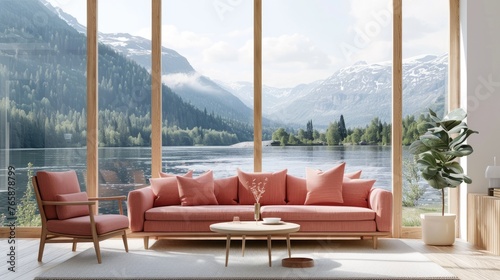 Sofa and armchair in front of large windows overlooking mountains.