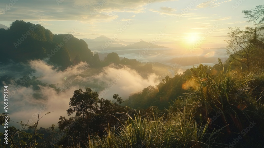 Naklejka premium Beautiful sunrise over the mountain with fog and grass