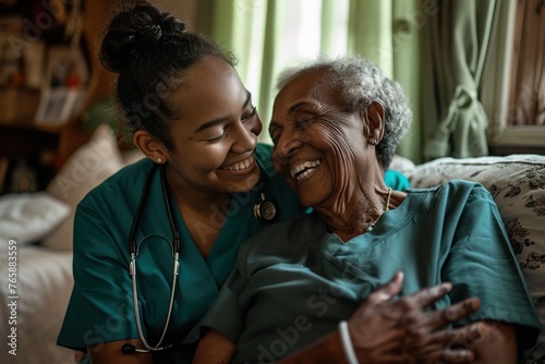 Smiling nurse in green scrubs chats with elderly woman at home