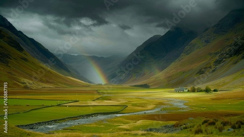  a rainbow shines in the sky over a valley with a stream in the foreground and mountains in the background.