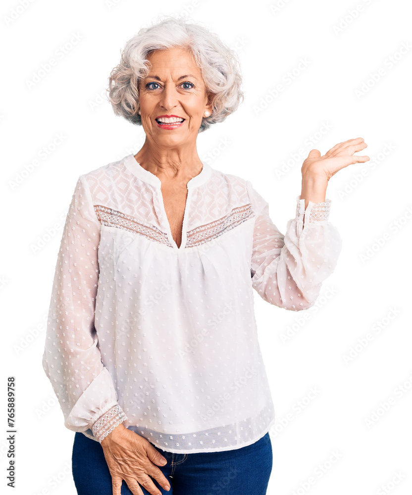 Senior grey-haired woman wearing casual clothes smiling cheerful presenting and pointing with palm of hand looking at the camera. Senior grey-haired woman wearing casual clothes smiling cheerful presenting and pointing with palm of hand looking at the camera.