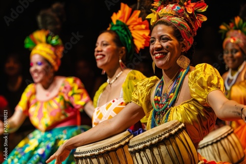 A group of women are dressed in vibrant, colorful costumes, standing together in a lively and energetic pose