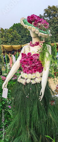 Mannequin beautifully dressed with flowers and leaves looks fairy tales