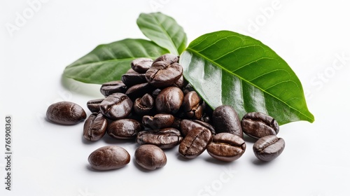 Roasted coffee beans spilling from a scoop with green coffee leaf on a white background. Close-up shot with space for text