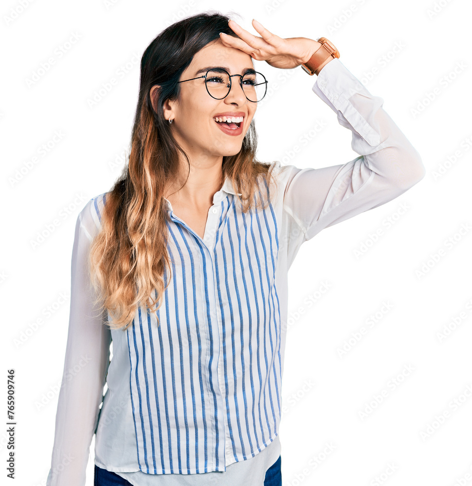 Beautiful hispanic woman wearing casual striped shirt very happy and smiling looking far away with hand over head. searching concept. Beautiful hispanic woman wearing casual striped shirt very happy and smiling looking far away with hand over head. searching concept.