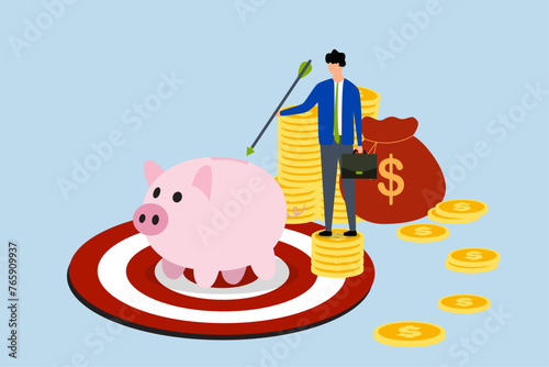 Financial goal, businessman investor holding arrow in stack of coins with piggy bank on pinball table