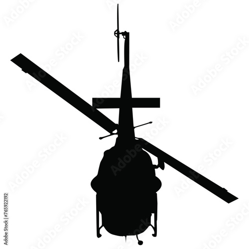 A tail view silhouette of a helicopter in flight