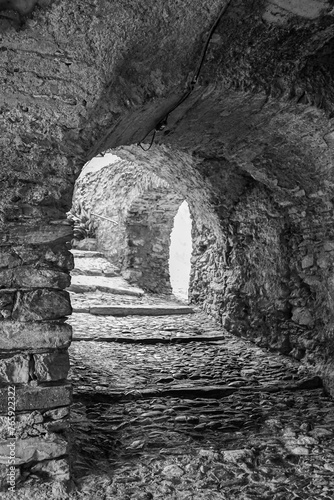 Black and white photo. Uphill stone arcade in the 