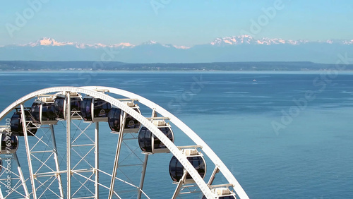 Ferris wheel with a view of the sky, sea and mountains in the background