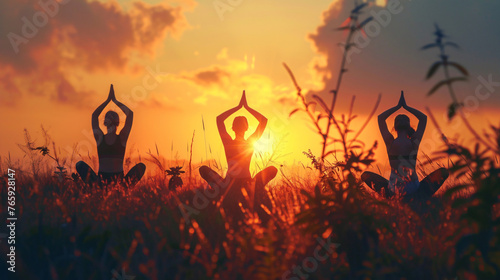 Group of people doing yoga in the park, sunset view