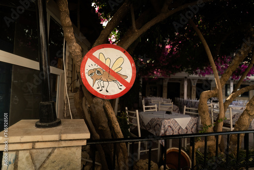 Obraz na płótnie A restaurant with a sign stating mosquitoes are banned in Greece w salonie