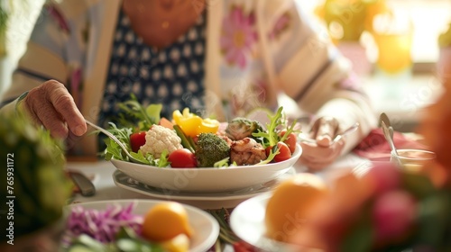 Senior woman serving herself a healthy and colorful vegetable salad at a communal dining table. Nutrition for the elderly and community meal concept for senior care brochures