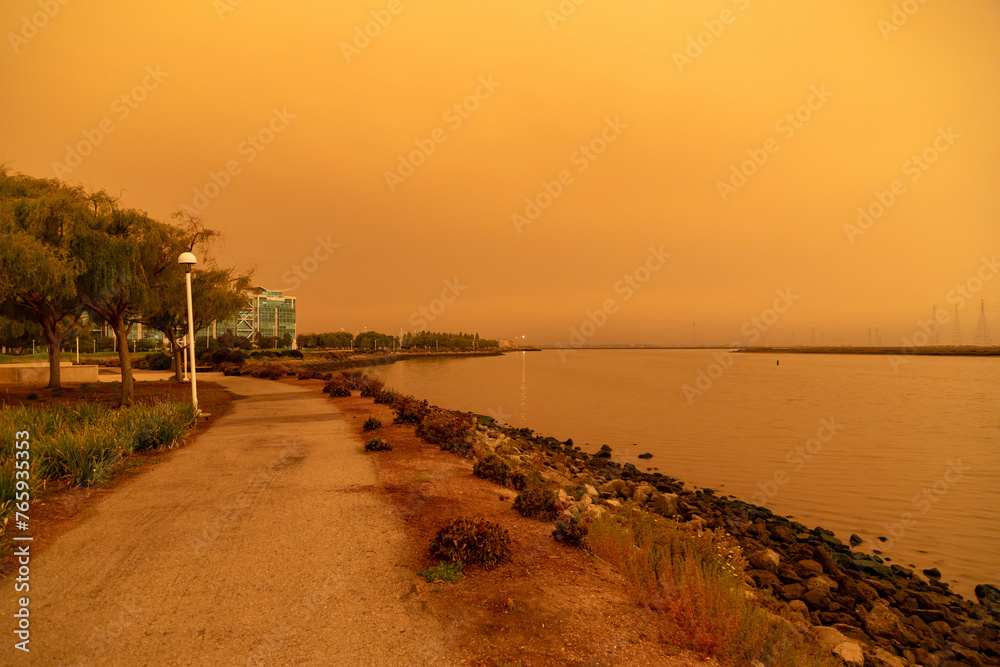 California Westpoint Slough on San Francisco Bay, California; Orange Smoke Filled Skies from Nearby Out of Control Wildfires Caused by Drought and Climate Change