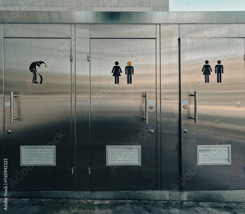 Bathroom Stall Humor. Public bathroom stalls in Basel, Switzerland. Humorous icons on the front of each stall door for men, woman and wizards.