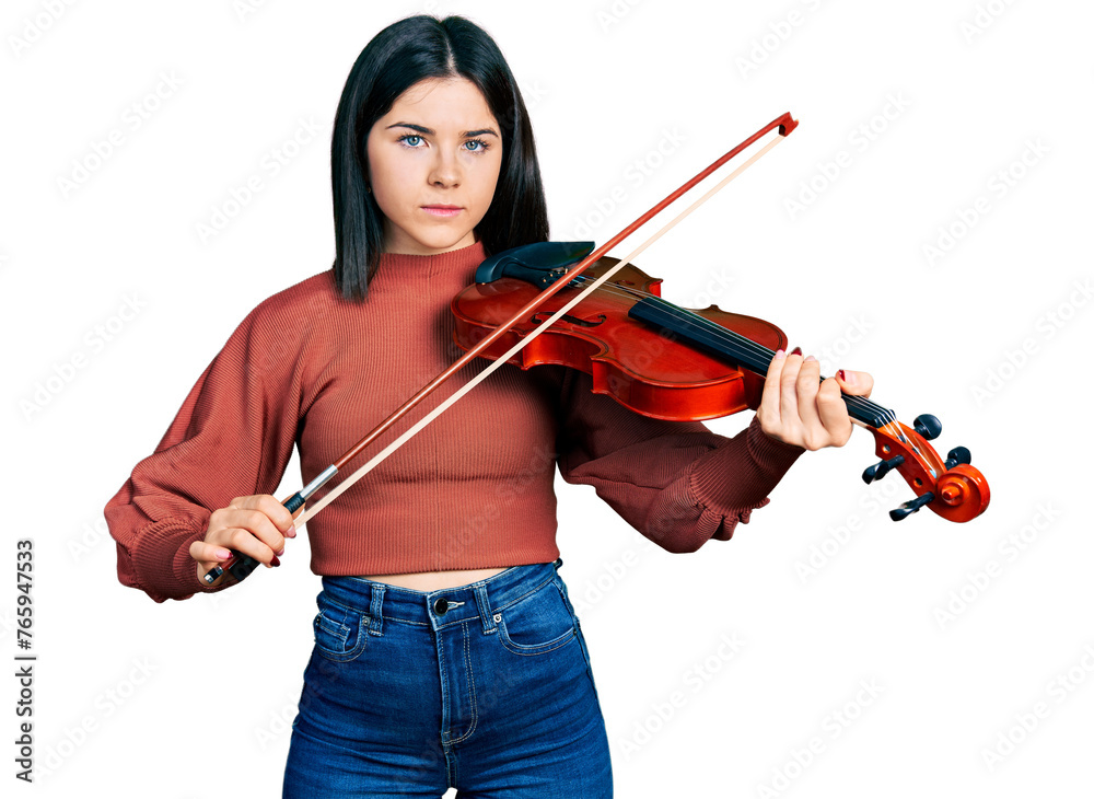 Young brunette woman with blue eyes playing violin relaxed with serious expression on face. simple and natural looking at the camera. Young brunette woman with blue eyes playing violin relaxed with serious expression on face. simple and natural looking at the camera.
