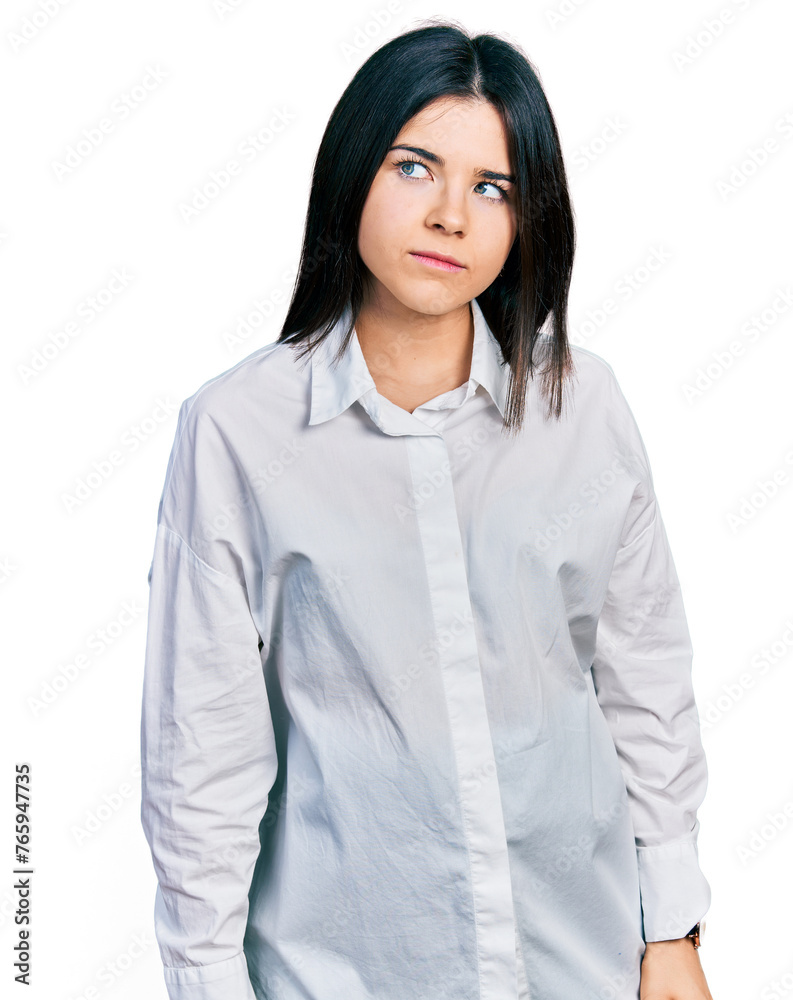 Young brunette woman with blue eyes wearing oversize white shirt looking sleepy and tired, exhausted for fatigue and hangover, lazy eyes in the morning. Young brunette woman with blue eyes wearing oversize white shirt looking sleepy and tired, exhausted for fatigue and hangover, lazy eyes in the morning.