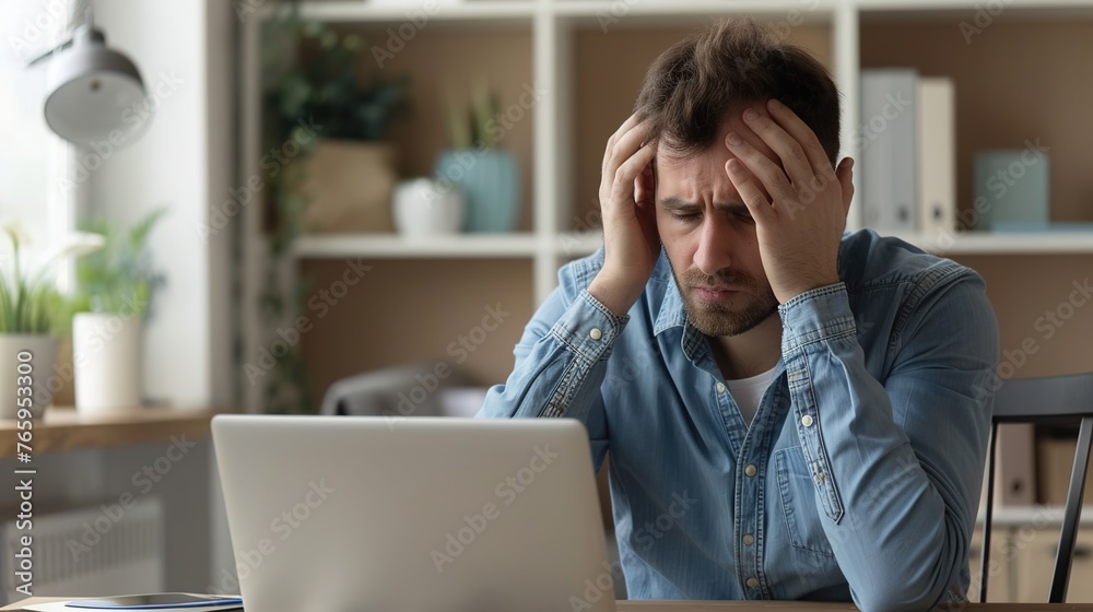 Side profile view man sitting at desk, holding head in hands, looking at laptop screen in despair. A male worker accidentally deletes important data or can't fix computer error and program malfunction Side profile view man sitting at desk, holding head in hands, looking at laptop screen in despair. A male worker accidentally deletes important data or can't fix computer error and program malfunction