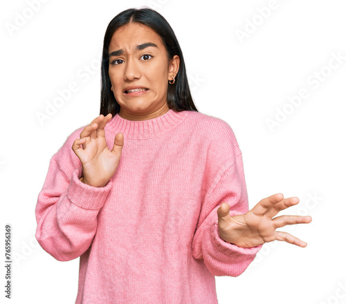 Young asian woman wearing casual winter sweater disgusted expression, displeased and fearful doing disgust face because aversion reaction.