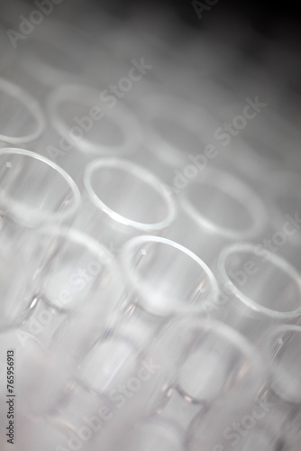 Close-up of a transparent plastic 96-well plate used for luminescence measurement in biology - shallow depth of field