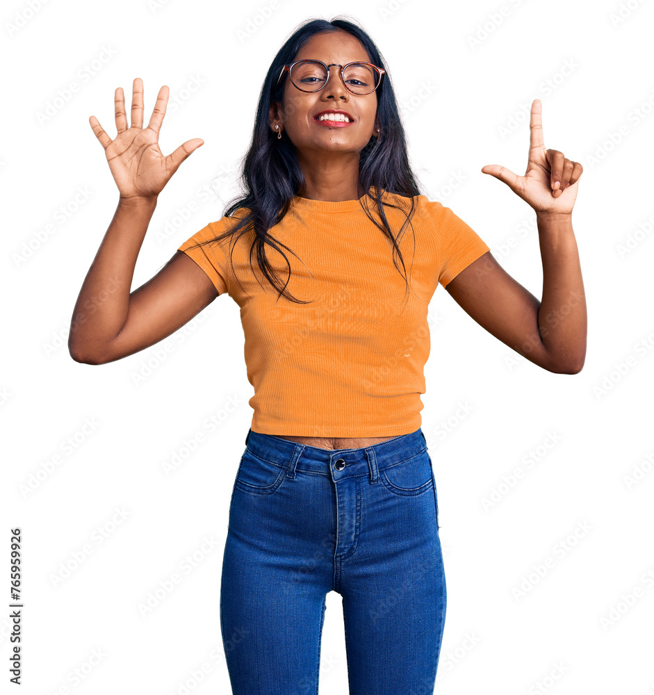 Young indian girl wearing casual clothes and glasses showing and pointing up with fingers number seven while smiling confident and happy. Young indian girl wearing casual clothes and glasses showing and pointing up with fingers number seven while smiling confident and happy.