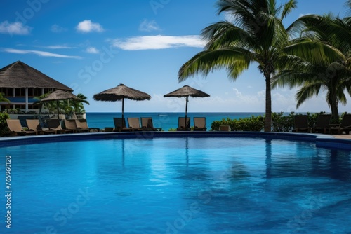 Tropical resort with a pool overlooking the ocean © BetterPhoto