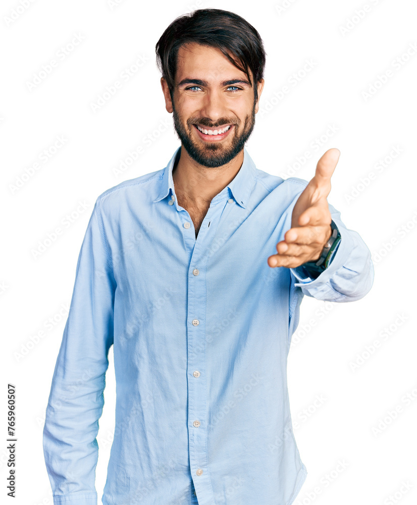 Hispanic man with blue eyes wearing business shirt smiling friendly offering handshake as greeting and welcoming. successful business. Hispanic man with blue eyes wearing business shirt smiling friendly offering handshake as greeting and welcoming. successful business.