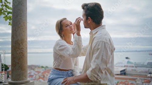 Love pair caressing faces at seascape date closeup. Man touching enamoured woman