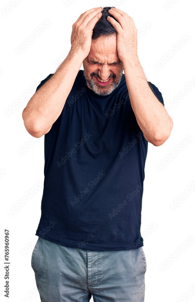 Middle age handsome man wearing casual t-shirt suffering from headache desperate and stressed because pain and migraine. hands on head. Middle age handsome man wearing casual t-shirt suffering from headache desperate and stressed because pain and migraine. hands on head.
